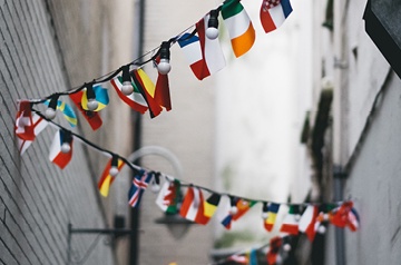 international flags hanging in alleyway