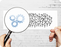 question marks becoming cogs when viewed through magnifying glass