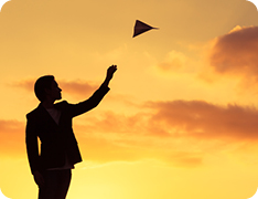 silhouette of businessman throwing paper airplane