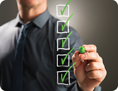 man checking boxes with a green marker