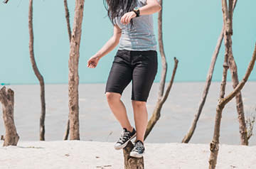 balancing on driftwood on beach