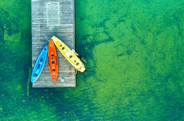 three empty kayaks on pier