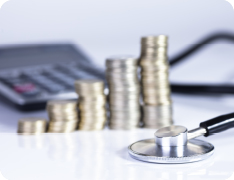 stethoscope on desk next to calculator and neatly sorted coins