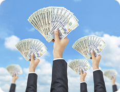 sleeved arms holding fanned cash in the air