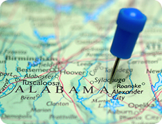 Closeup of blue pin in map of Alabama