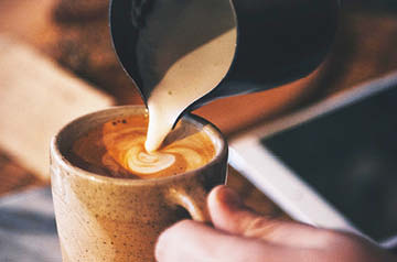 barista pouring latte art