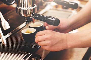 Barista pulling espresso shots