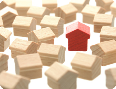 miniature wooden houses, one painted red